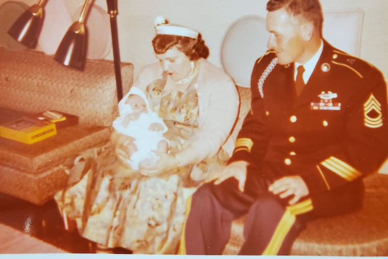 Korean War veteran and POW Joseph J. Daly (right) at a family christening in 1957 for his godson. His niece, Marianne Bustin, is on a quest for Daly's sacrifice to be remembered.