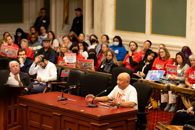Derek Sam, a Chinatown resident and business owner, speaks at a recent City Council hearing in opposition to the 76ers' proposal to build an arena in Center City as fellow Chinatown advocates look on.