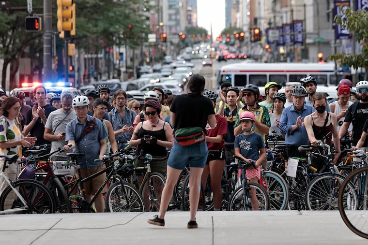 Philly Bike Action’s Yolanda Gomez-Galvez (back to camera) speaks at City Hall in July. Cyclists biked from the Art Museum to City Hall to protest what they see as a lack of commitment to traffic safety from the mayor.